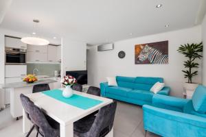 a living room with a blue couch and a table at Villa Muller Apartments in Split