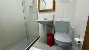 a bathroom with a toilet and a sink at Caminho de Itacoatiara in Niterói