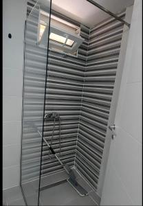 a shower with a glass door in a bathroom at Guest House Nadol SUP and Bikes included in Ohrid