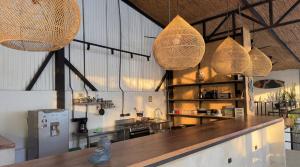 a kitchen with baskets hanging from the ceiling at Aduana House in Santa Teresa Beach