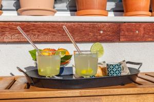 two drinks on a tray on a table at Mimice Hills Luxury Penthouse 229 m2, Panoramic Wrap Terrace, Jacuzzi,BBQ in Mimice +68 photos
