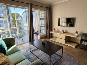 a living room with a couch and a table at Luxurious 2Bed ,Iconic Views Mountain& Beach in Big Bay