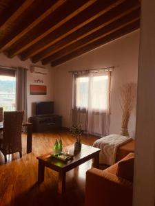 a living room with a couch and a table at Villa Mattei Franciacorta in Villa Pedergnano