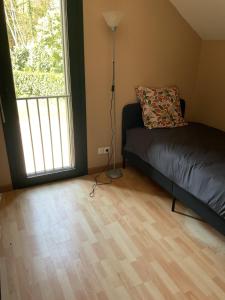 a bedroom with a bed and a large window at Logement au bord de l eau in Dordives