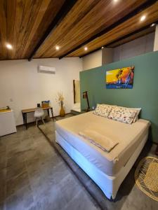 a bedroom with a large bed in a room at Biruta's Beach House - Taíba in São Gonçalo do Amarante