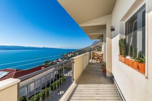 a balcony with a view of the water at Mimice Hills Luxury Penthouse 229 m2, Panoramic Wrap Terrace, Jacuzzi,BBQ in Mimice