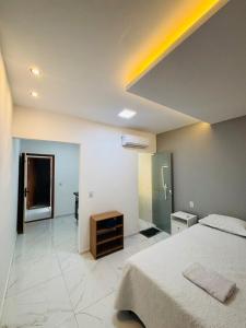 a large bedroom with a bed and a mirror at Flats Sucesso in Teresina