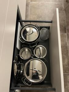 a drawer filled with silver pots and pans at ALandGIO Smart Stay in Cavallino-Treporti