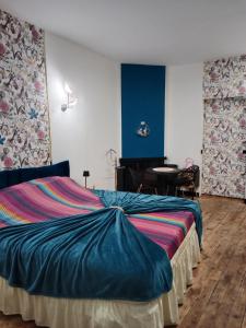a bedroom with a large bed and a table at Chambre d'hôtes studio proche mer Mers-les-bains in Gamaches