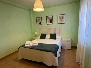 a bedroom with a bed with two shoes on it at Casa Tío Tato , cerca de Puy du Fou y Toledo in Polán