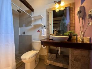 a bathroom with a toilet and a sink at Tropicana La Catedral in Antigua Guatemala +28 photos