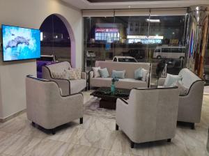 a living room with couches and chairs and a tv at كاسا للشقق المخدومة 2 in Dammam