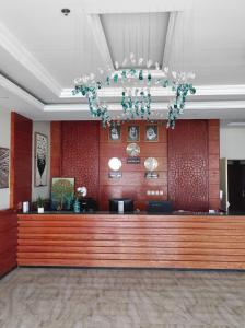 a lobby with a large wooden reception desk at كاسا للشقق المخدومة 2 in Dammam