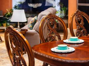 a wooden table and chairs with bowls on top of it at Solanza Hotel Hacienda in Cancún