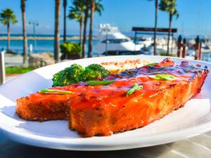 a plate of food with broccoli on a table at Hotel Coral & Marina in Ensenada