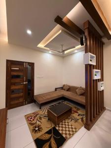 a living room with a couch and a table at Diga Vista Lake View 4BHK Swimming Pool Cottage Munnar in Munnar