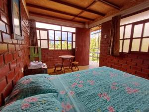 a bedroom with a bed in a room with windows at Casa Hospedaje el Prado Eco turismo in Oxapampa