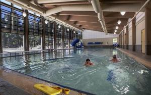 two people swimming in an indoor swimming pool at Lodge Room 020 in Black Butte Ranch +7 photos