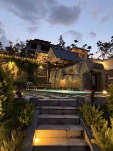 a house with a swimming pool and some stairs at Diga Vista Lake View 4BHK Swimming Pool Cottage Munnar in Munnar