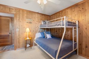 a bedroom with two bunk beds in a cabin at Happy Ours in Corolla