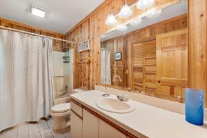 a bathroom with a sink and a toilet at Happy Ours in Corolla +14 photos