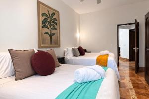 a hotel room with two beds in a room at Solanza Hotel Hacienda in Cancún +25 photos