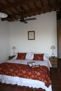 a bedroom with a large bed with a red blanket at Estancia La Sofia in San Andrés de Giles +42 photos