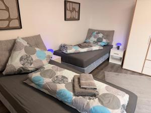 a living room with two beds and a couch at Casa Daniela Residence in Vilshofen an der Donau