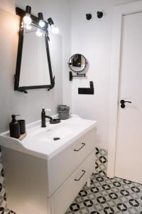 a bathroom with a white sink and a mirror at Casa Deitania I in Caravaca de la Cruz