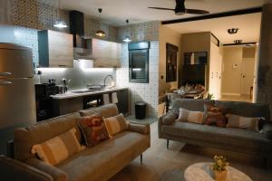 a living room with two couches and a kitchen at Casa Deitania I in Caravaca de la Cruz