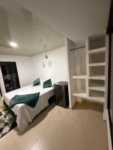 a bedroom with a bed and a book shelf at Edificio La Roca in Pereira