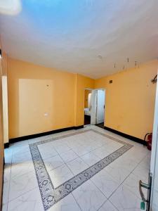 an empty room with yellow walls and a tile floor at Kelany Palace Hotel Aswan in Aswan