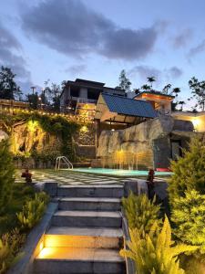 a garden with stairs leading up to a building at Diga Vista Lake View 4BHK Swimming Pool Cottage Munnar in Munnar