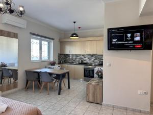 a kitchen with a table and a dining room at Airport Suites Michelle in Spata