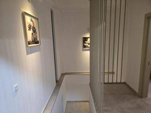 a hallway with two pictures on the walls of a museum at Gurgen Cottage in Ureki