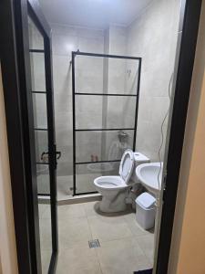 a bathroom with a toilet and a glass shower at Gurgen Cottage in Ureki +11 photos