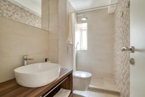 a white bathroom with a sink and a toilet at SM Beach Residence in Petrovac na Moru +38 photos
