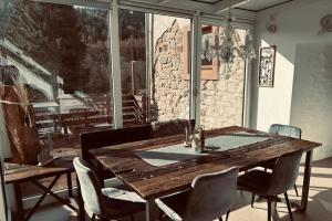 a wooden table and chairs in a room with a window at Ferienparadies in der Vulkaneifel in Roth