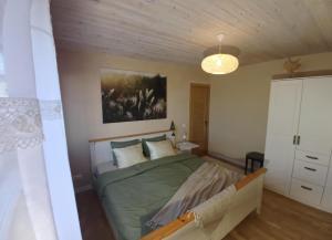 a bedroom with a bed and a painting on the wall at Savi sviit in Mooste