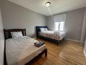 a bedroom with two beds and a window at Condo ville de quebec in Quebec City