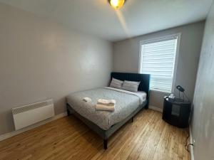 a bedroom with a bed with two towels on it at Condo ville de quebec in Quebec City