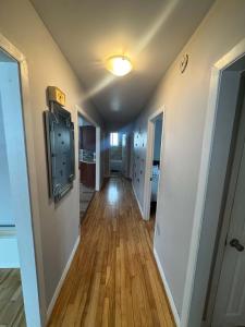 a hallway of a home with wooden floors at Condo ville de quebec in Quebec City