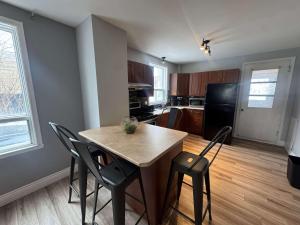 a kitchen with a table and chairs in a room at Condo ville de quebec in Quebec City +14 photos