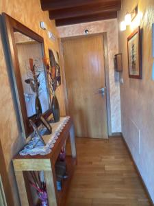 a hallway with a table with a mirror and a door at Area 3B in Camariñas +5 photos