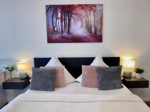 a bedroom with a large bed with two night stands at Prime Host Sophie Deluxe Apartment in Karlsruhe