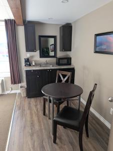 a small kitchen with a table and a sink at Beaver Motel in Wawa