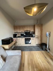a living room with a couch and a kitchen at Ninon et ses sommets in Cauterets