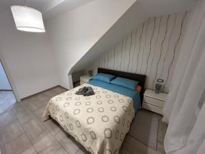 a bedroom with a bed with blue pillows at Boffi house in Sezze