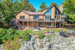 an exterior view of a log home with a large deck at New: Lake Access with Dock Slip More in Swanton
