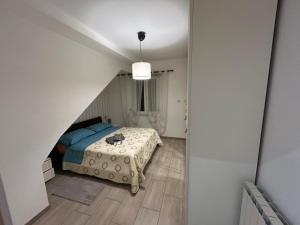 a bedroom with a bed in a room with a staircase at Boffi house in Sezze +7 photos